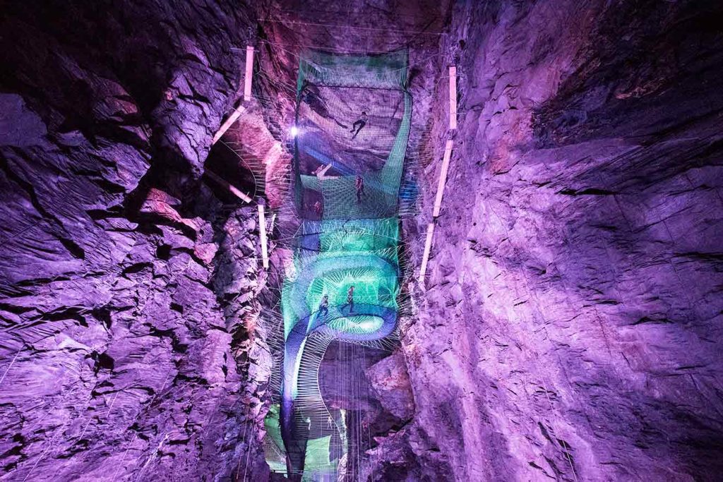 Bounce below in Wales features underground large cave with a series of trampoline nets and tube slides at the middle