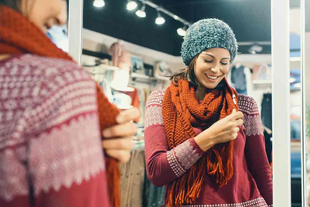 Woman wearing a scarf and cap during winter season are essential for Guide to Packing for Winter in Europe