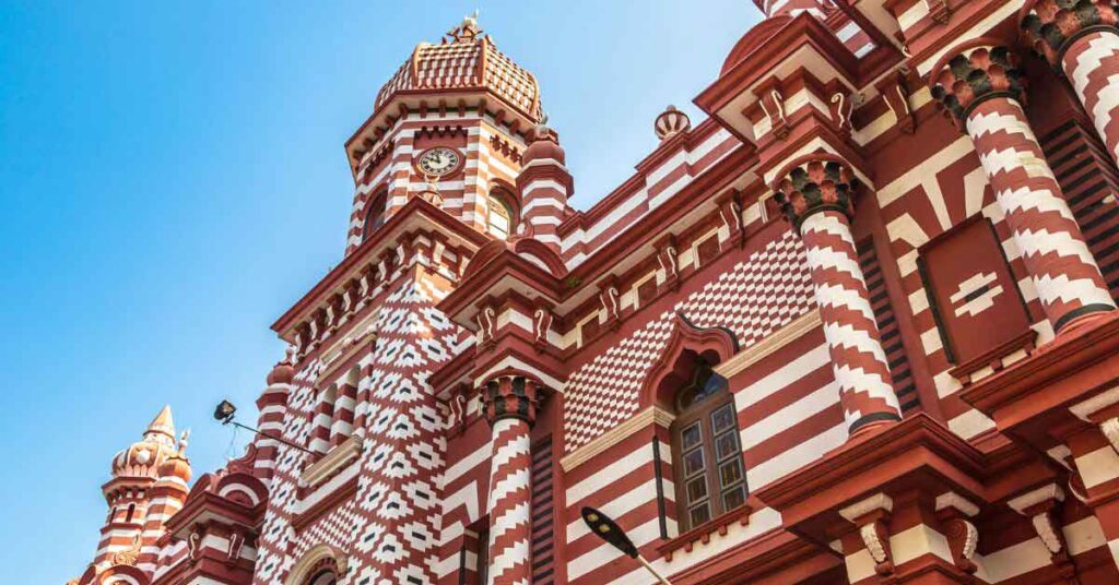 The red and white bricked facade of the Jami Ul-Alfar Mosque (Red Mosque) in Colombo. Visiting it is one of the best things to do in colombo in one day.